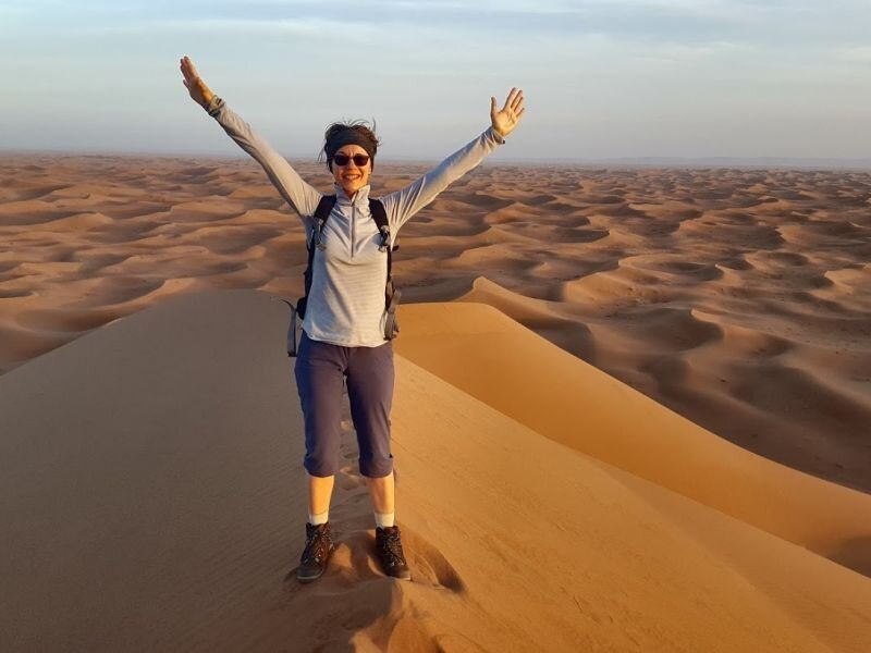 Traveller standing on Moroccan desert dunes